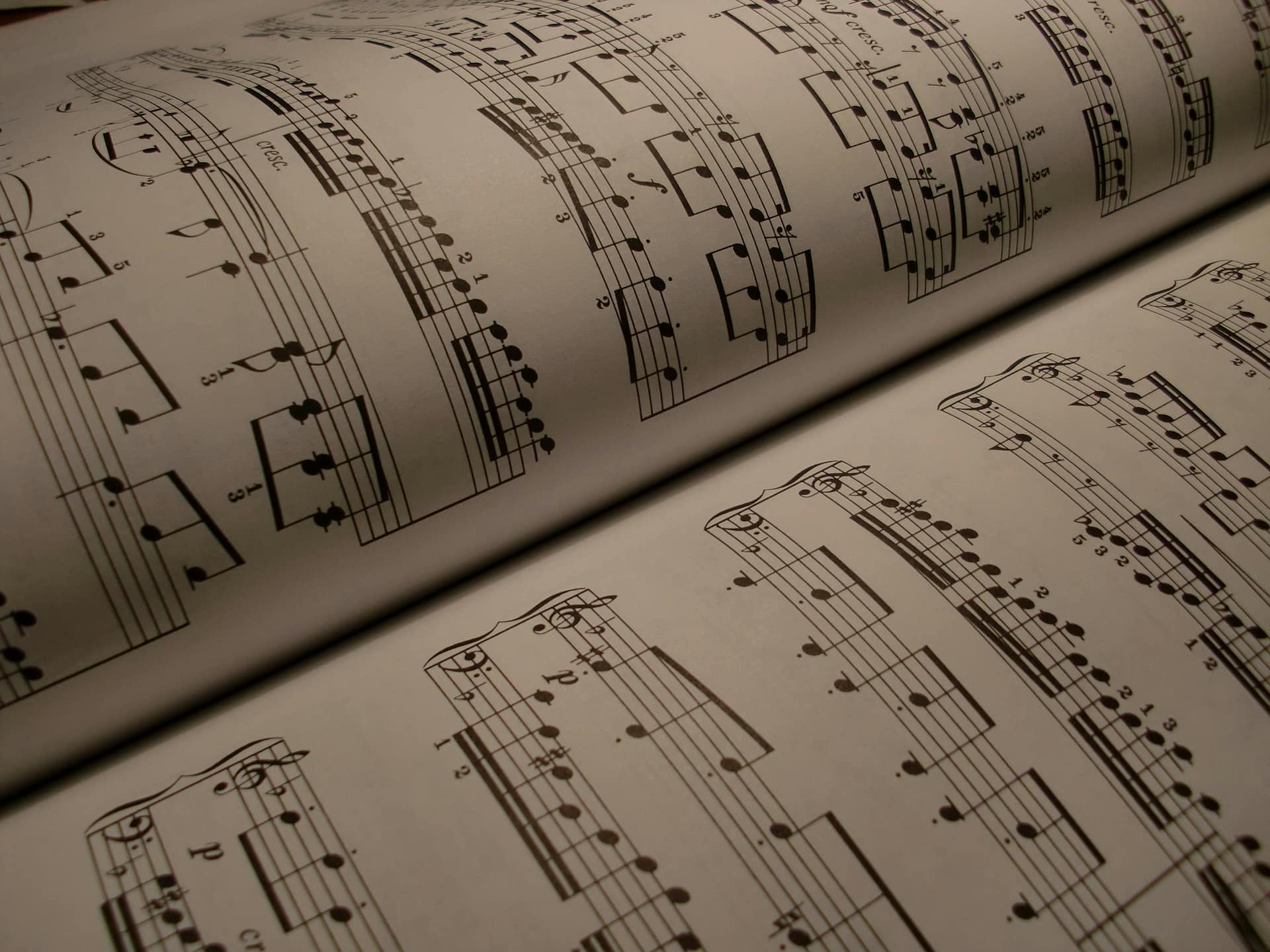 Detailed view of an open music book displaying musical notes and sheet music.